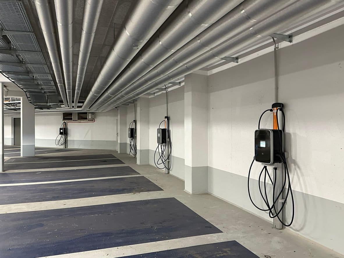 Quatre borne de recharge dans un parking public.