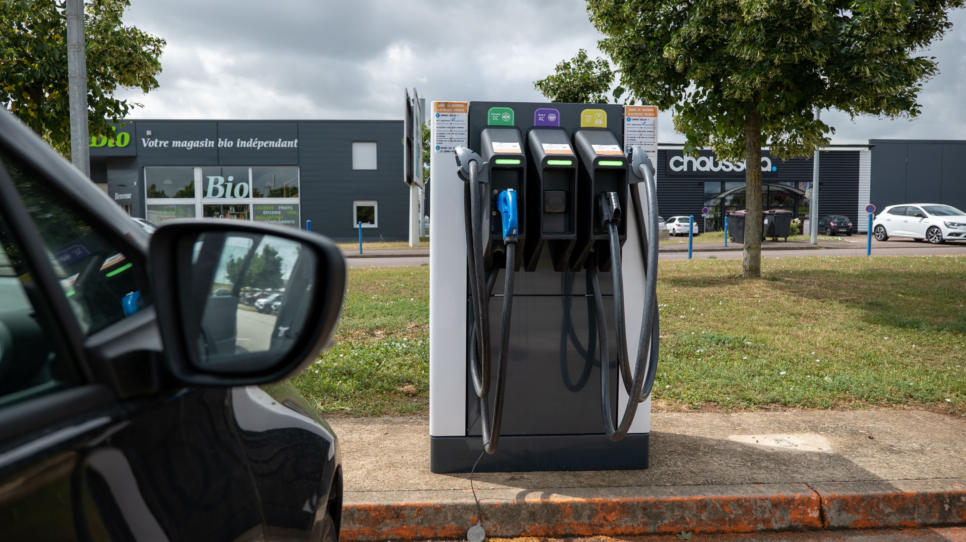 Une borne de recharge publique située dans une zone commerciale en France.